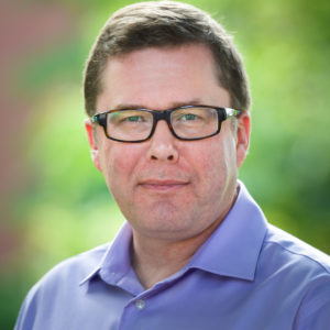 Headshot of Tom Engel in an outdoor setting.